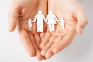 hands holding paper family